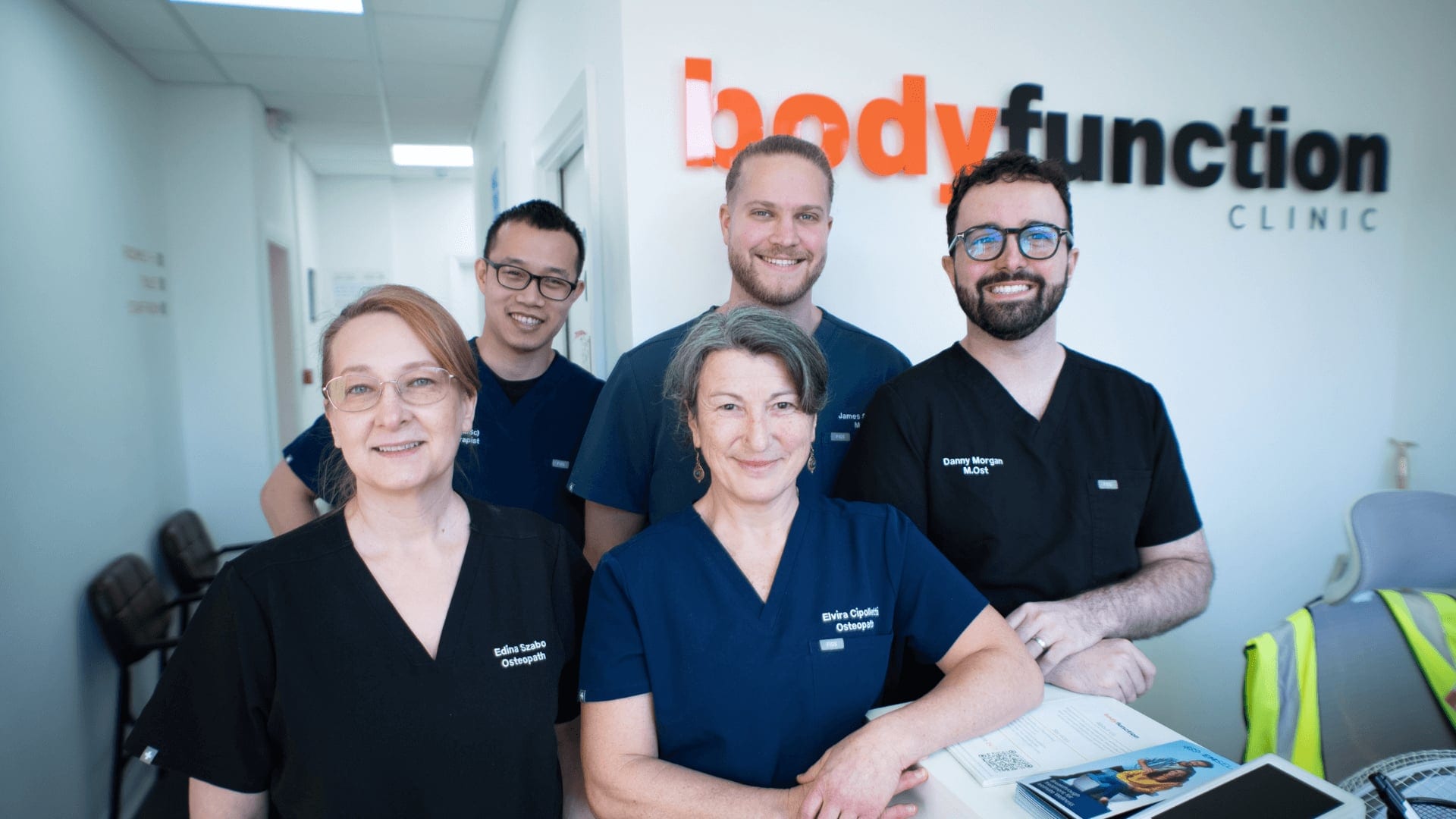 Reception team welcoming patients at an Osteopathy & Physiotherapy Clinic in Islington