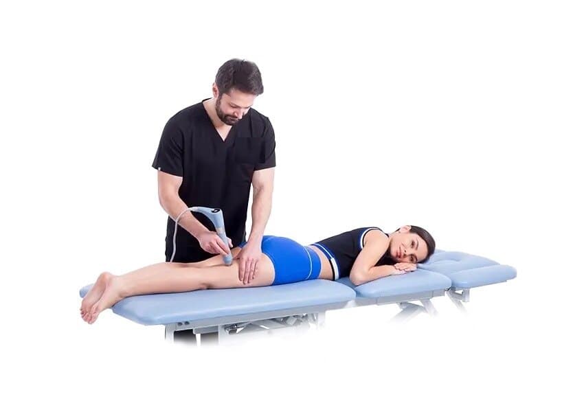 Clinician applying radial shockwave therapy to the back of a patient’s thigh